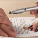 Wife and husband signing divorce documents or premarital agreement